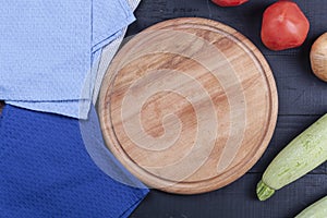 Kitchen wooden board with vegetables on wooden background