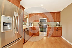 Kitchen with wooden cabinets, granite counter top and hardwood floor