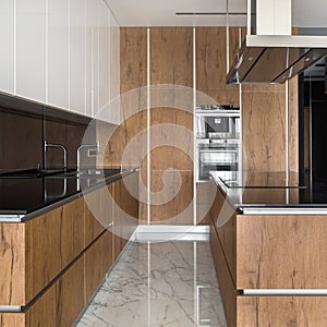 Kitchen with wooden cupboards and wall