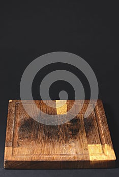 Kitchen wooden cutting board isolated on black background, food photography concept.