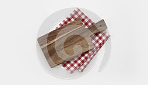 Kitchen wooden cutting board top view decorated with red picnic checkered cloth, serving dish empty space design, tableware on