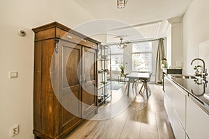 a kitchen with wooden floors and a wooden armoire