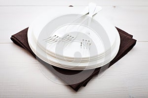 Kitchen. Wooden table with empty plate, tablecloth for dinner.