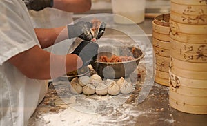 Kitchen workers prepare meat dumplings