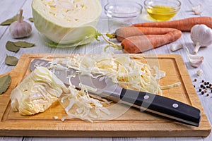 Kitchen workspace with the process of shredding white cabbage