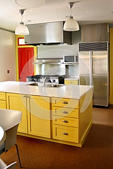 Kitchen yellow wood cabinets stainless stove