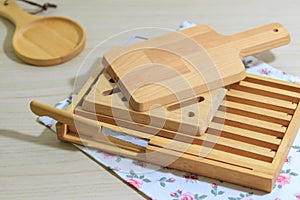 Kitchenware collecttion set, Vintage cutting wood board and tray with bread knife lie on cloth napkin
