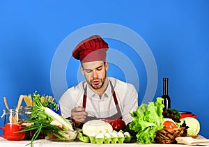 Kitchenware and cooking concept. Man in cook hat and apron