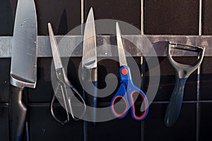 Kitchenware and scissors on the magnetic line