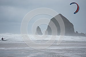 Kite boarder with sea stacks in background