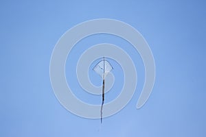 Kite fly in the wind. Kite Flying against Sky isolated on blue Background