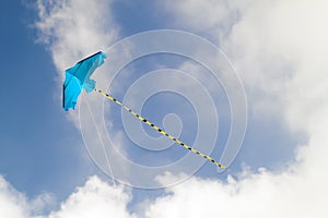 Kite flying against the blue sky on a sunny day