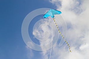 Kite flying against the blue sky on a sunny day