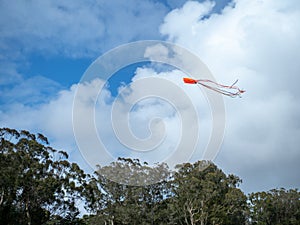 Kite flying high in the sky with parting clouds