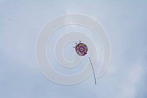 kite flying in the sky with shapes and colors