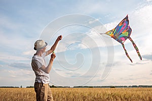 Kite in hand against the blue sky in summer, flying kite launching, fun summer vacation, under the field, freedom