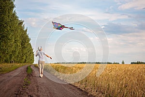 Kite in hand against the blue sky in summer, flying kite launching, fun summer vacation, under the field, freedom