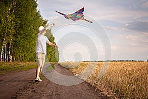 Kite in hand against the blue sky in summer, flying kite launching, fun summer vacation, under the field, freedom