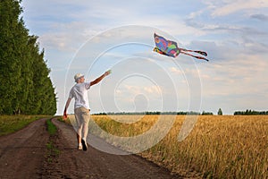 Kite in hand against the blue sky in summer, flying kite launching, fun summer vacation, under the field, freedom
