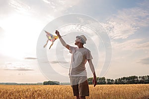 Kite in hand against the blue sky in summer, flying kite launching, fun summer vacation, under the field, freedom