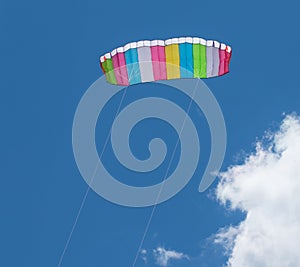 Kite parachute flying in the sky among the clouds