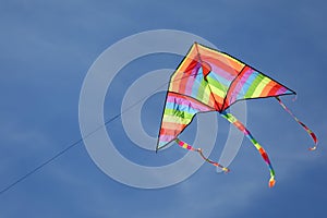 Kite with rainbow colors flying in the sky symbol of hope joy brotherhood photo