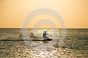 Kite surfer on Aruba island in the Caribbean at sunset