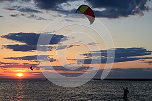 A kite surfer brings in his kite at the end of the day