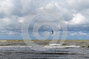 Kite surfer enjoys a brisk wind on the Baltic seashore in Pavilosta