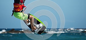 Kite surfer flying over the wave