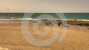 Kite surfer glides on the sea waves