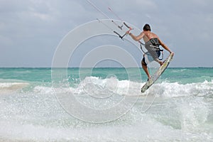 Kite surfer jumping wave