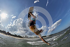 Kite surfer jumps with kiteboard