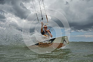 Kite surfer jumps with kiteboard