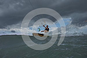 Kite surfer jumps with kiteboard