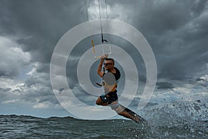 Kite surfer jumps with kiteboard