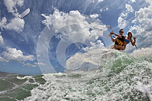 Kite surfer jumps with kiteboard