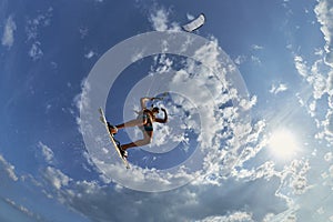 Kite surfer jumps with kiteboard