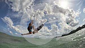 Kite surfer jumps with kiteboard photo