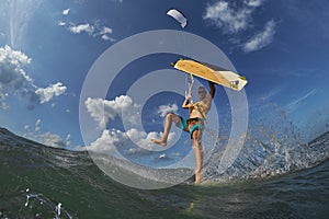 Kite surfer jumps with kiteboard photo