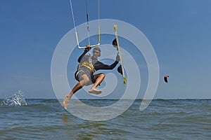 Kite surfer jumps with kiteboard photo