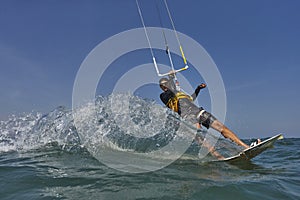 Kite surfer jumps with kiteboard photo