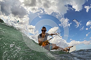 Kite surfer jumps with kiteboard in transition photo