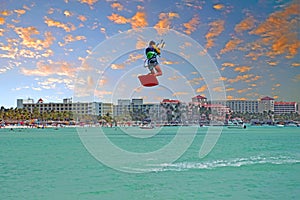 Kite surfer at Palm Beach on Aruba island at sunset