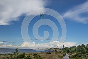 A kite surfer rides on the sea. Kites in the sky. photo