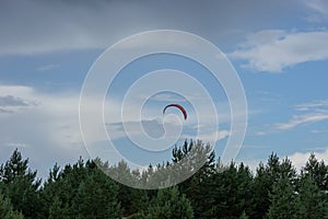 A kite surfer rides on the sea. Kites in the sky.