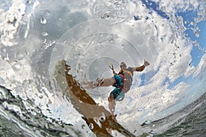 Kite surfer jumps with kiteboard photo