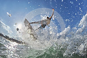 Kite surfer jumps with kiteboard photo