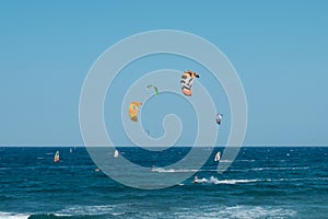 Kite board surfer and wind surfer on ocean at El Medano Beach
