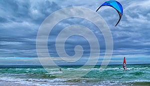 Kite surfer and wind surfer